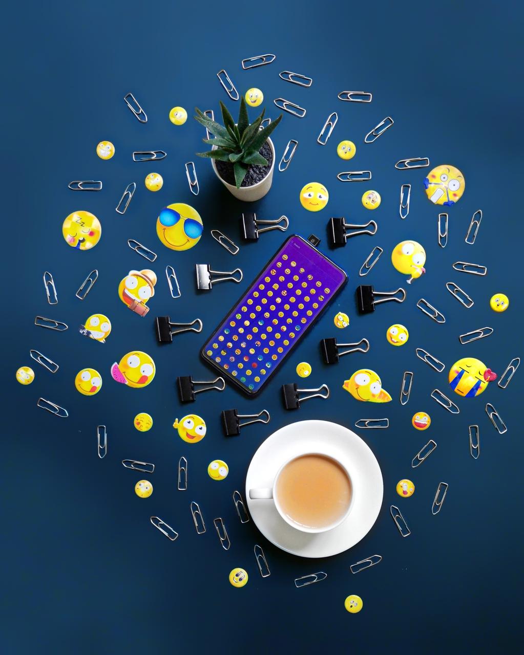 Paper clips, emoji, coffee, and a smartphone